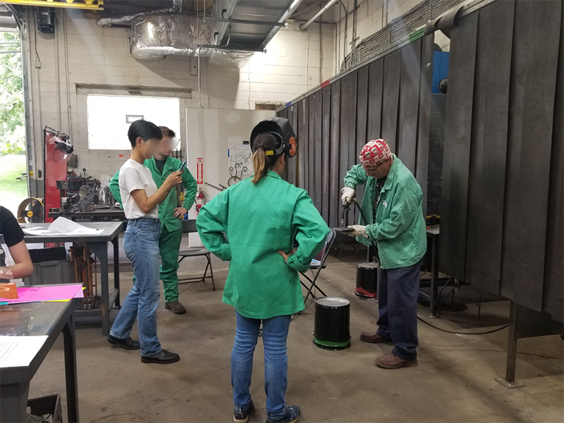 group of students learning welding